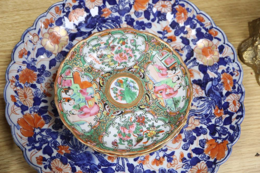 A collection of mixed Chinese and Japanese porcelain and pottery including a Nanking Cargo blue and white tea bowl, a 19th century